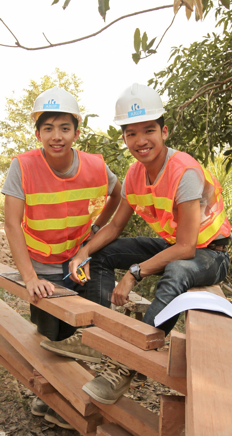 Two Arup enginners helping to build a community school in Cambodia